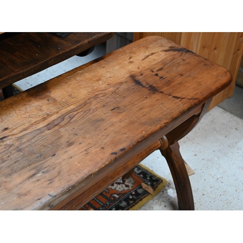 30A - A Victorian pitch pine gothic style hall bench on crossed supports united by the turned stretcher, 1... 