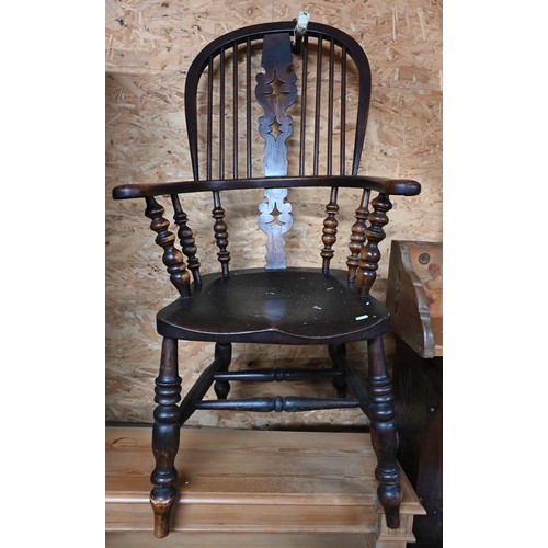 57 - An antique ash and elm Windsor chair on turned legs with stretchers