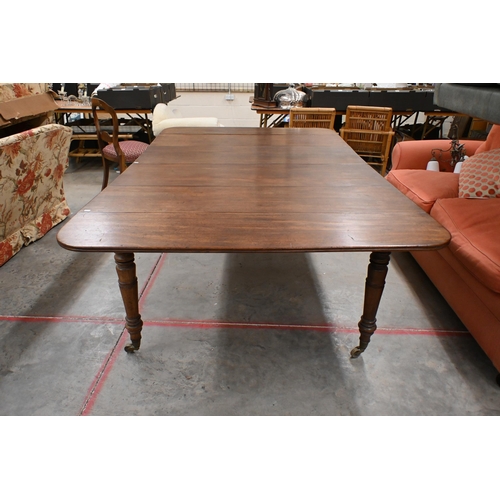 147 - # A 19th century mahogany extending dining table with drop-leaf ends and two central leaves raised o... 