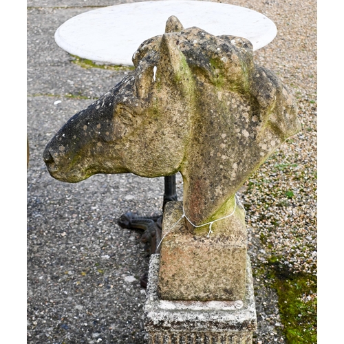 11 - A weathered cast stone horse's head garden ornament, raised on an associated square plinth