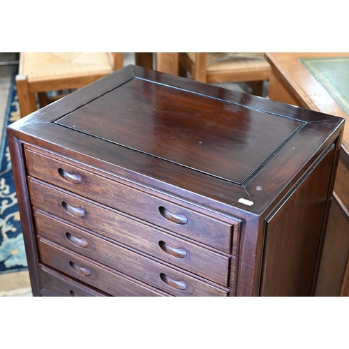 112 - # A vintage Chinese stained hardwood cutlery cabinet with five baize lined drawers over panelled cup... 