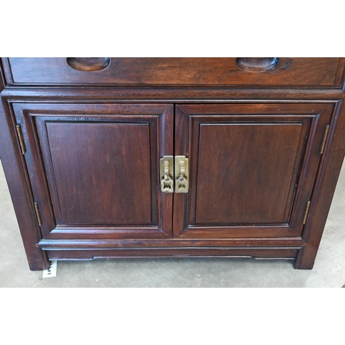 112 - # A vintage Chinese stained hardwood cutlery cabinet with five baize lined drawers over panelled cup... 