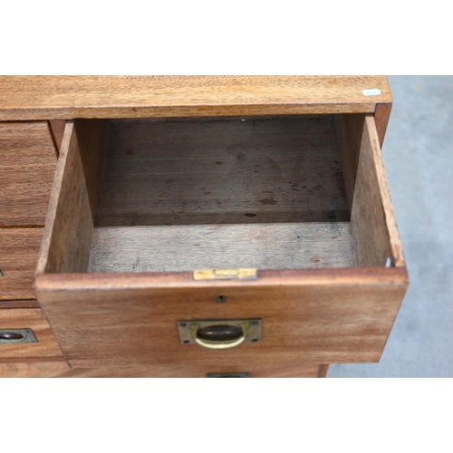 113 - A teak two-section campaign style chest with two short and three long drawers with brass handles, 92... 