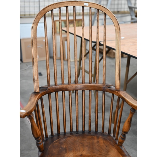 115 - A ash and elm Windsor armchair with turned legs and crinoline stretcher