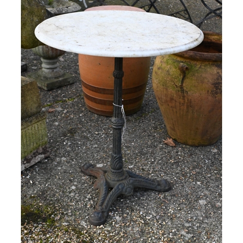 12 - A weathered circular marble top cast iron garden table