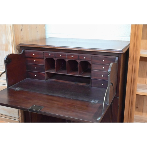 122 - A 19th century mahogany secretaire cabinet, the drop-front drawer with fitted interior over a pair o... 