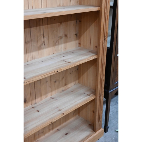 123 - A pair of modern stained pine open bookcases each with four fixed shelves, 90 cm w x 30 cm d x 182 c... 