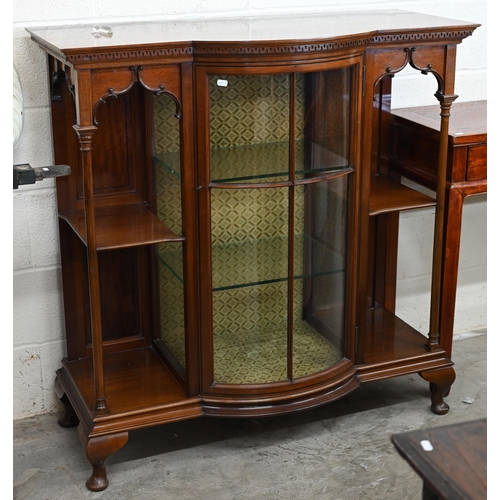 125 - An Edwardian walnut display cabinet with glazed bowfront central section flanked by open shelves and... 