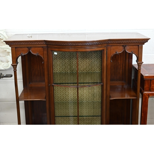 125 - An Edwardian walnut display cabinet with glazed bowfront central section flanked by open shelves and... 