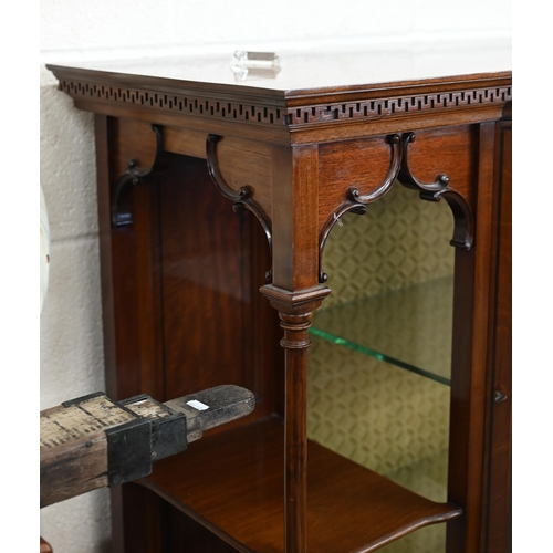 125 - An Edwardian walnut display cabinet with glazed bowfront central section flanked by open shelves and... 