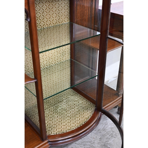 125 - An Edwardian walnut display cabinet with glazed bowfront central section flanked by open shelves and... 