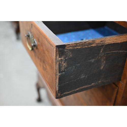 130 - An antique walnut feather banded chest on stand with two short and two long drawers, shaped apron an... 