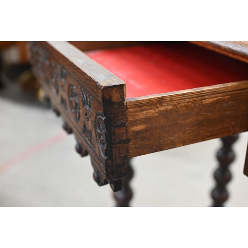 132 - A late Victorian Gothic revival carved oak console table with central lion mask motif between two dr... 