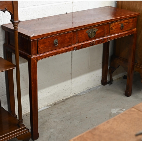 136 - A 20th century Chinese hardwood console/altar table with three drawers and brass handles, red lacque... 