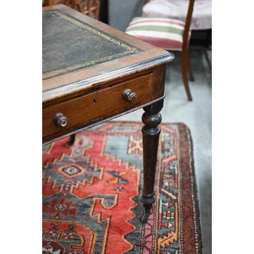 155 - A Victorian oak writing table with gilt tooled leather top and two drawers raised on turned fluted s... 