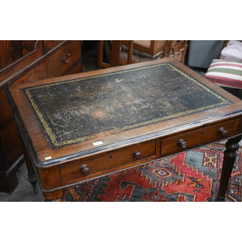 155 - A Victorian oak writing table with gilt tooled leather top and two drawers raised on turned fluted s... 