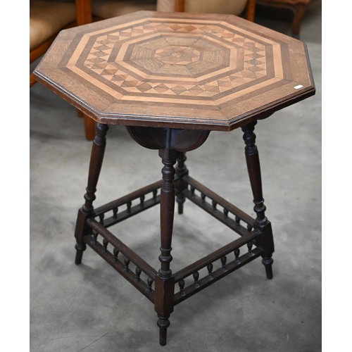 156 - An early 20th century oak and parquetry inlaid octagonal table on turned supports united by spindled... 