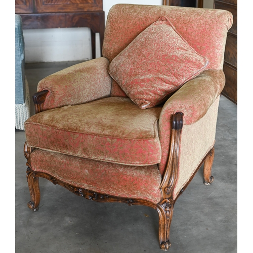 166 - An antique French carved walnut armchair upholstered in old gold and terracotta floral fabric, 82 cm... 