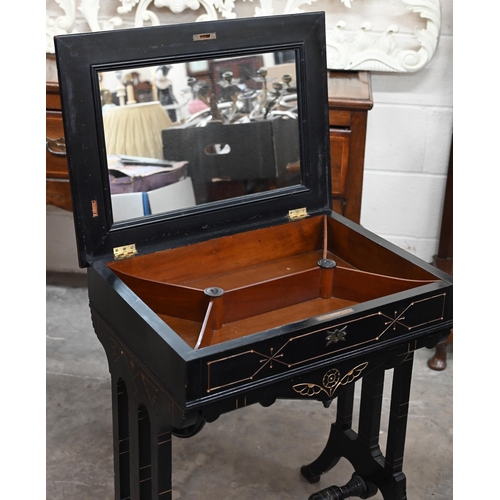 170 - A Victorian Aesthetic period ebonised work table, the hinged top fitted with underside mirror enclos... 