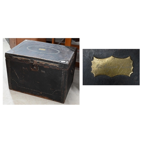 173 - An early/mid 19th century pine trunk covered in brass studded leather with side handles and ownershi... 