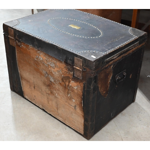 173 - An early/mid 19th century pine trunk covered in brass studded leather with side handles and ownershi... 