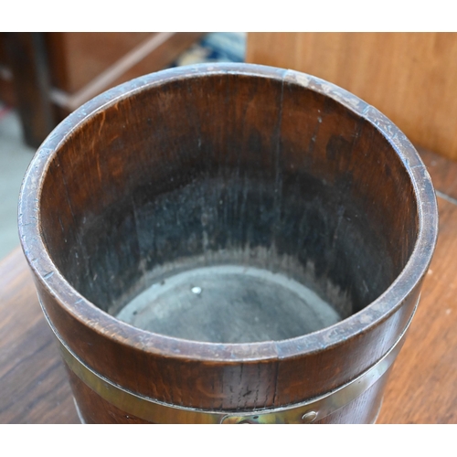 176 - A small coopered oak and brass bound bucket, 26 cm diameter x 23 cm h