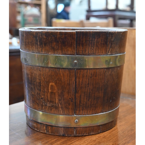 176 - A small coopered oak and brass bound bucket, 26 cm diameter x 23 cm h