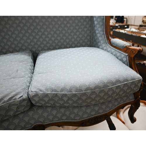 178 - An early 20th century French salon settee with carved walnut frame, re-upholstered in blue imbricate... 