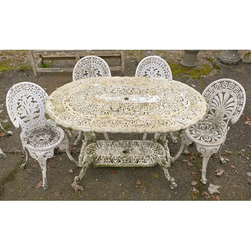 2 - A weathered Victorian style cast terrace dining table and four chairs set, umbrella socket to table ... 