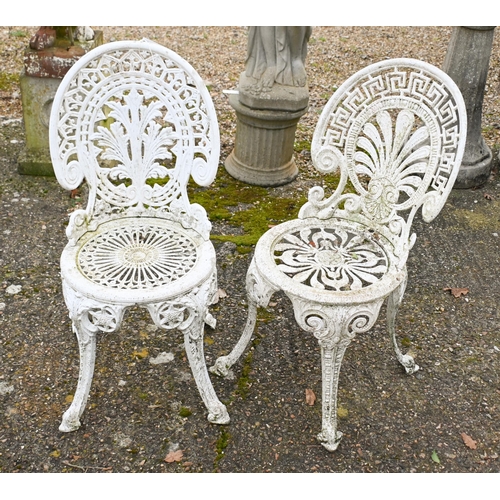 2 - A weathered Victorian style cast terrace dining table and four chairs set, umbrella socket to table ... 