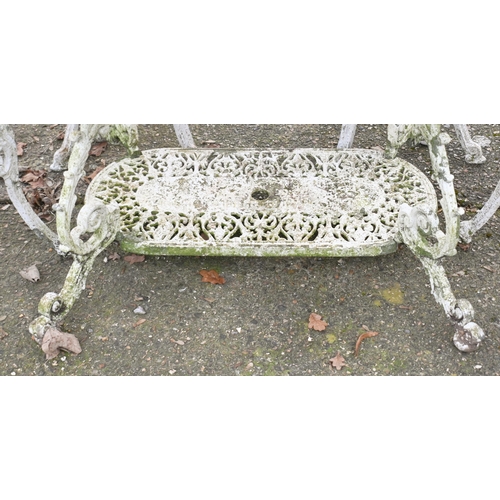 2 - A weathered Victorian style cast terrace dining table and four chairs set, umbrella socket to table ... 