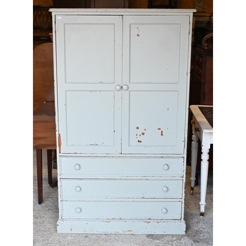 21 - A painted pine two door dwarf wardrobe with three long graduated drawers beneath, on a plinth base 9... 