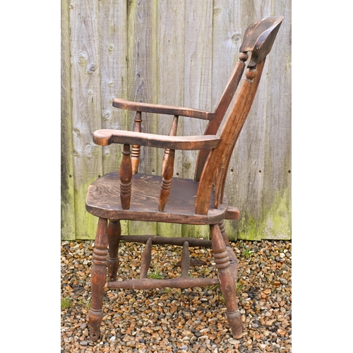 22 - An antique elm-seated Windsor chair, stamped 'GG'