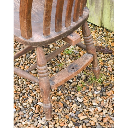 22 - An antique elm-seated Windsor chair, stamped 'GG'