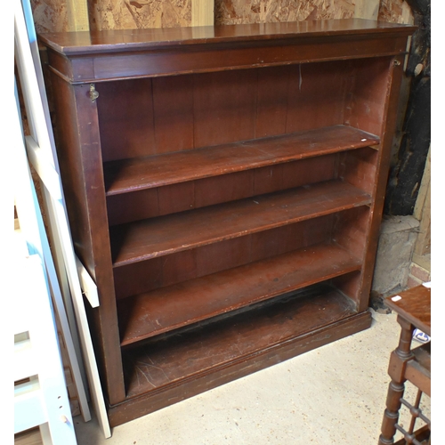 28 - An antique satinwood low open bookcase, with adjustable shelves on a plinth base