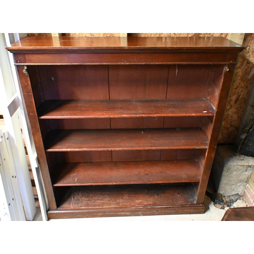 28 - An antique satinwood low open bookcase, with adjustable shelves on a plinth base