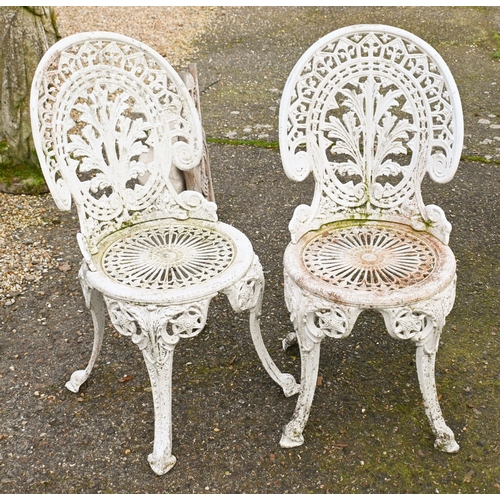 3 - A weathered Victorian style cast terrace dining table and four chair set (5)