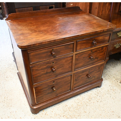 34 - A Victorian mahogany chest of six deep graduated drawers, with turned fittings and raised on a plint... 