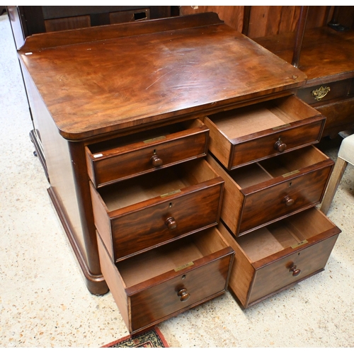 34 - A Victorian mahogany chest of six deep graduated drawers, with turned fittings and raised on a plint... 