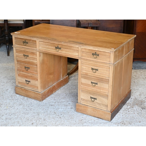 35 - # A Victorian ash twin pedestal desk, with nine drawers and brass fittings, raised on plinths to con... 