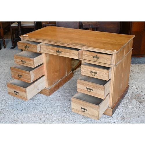 35 - # A Victorian ash twin pedestal desk, with nine drawers and brass fittings, raised on plinths to con... 