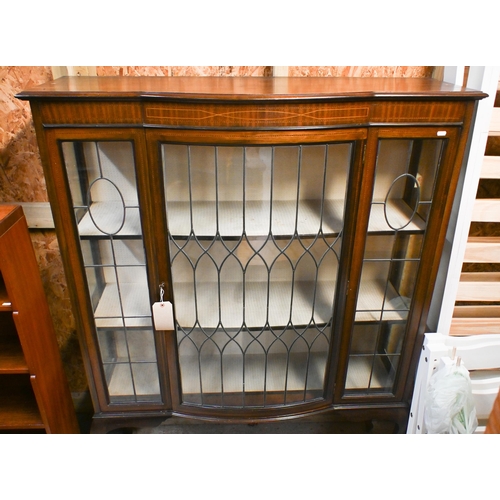 37 - An inlaid satinwood and lead light glazed bowfront display cabinet, the single door enclosing a fabr... 