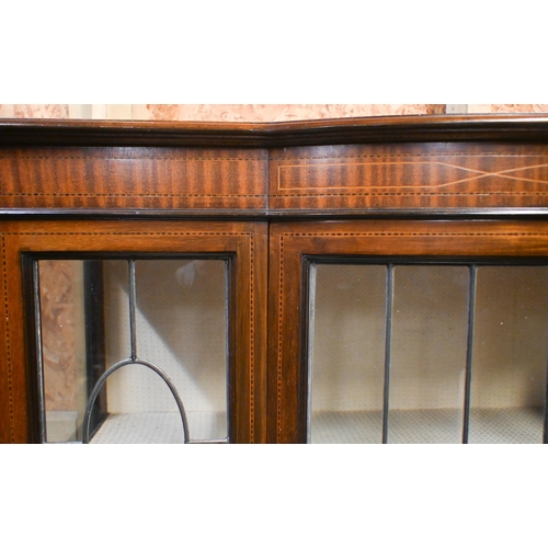 37 - An inlaid satinwood and lead light glazed bowfront display cabinet, the single door enclosing a fabr... 