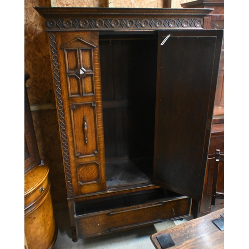 41 - An antique oak wardrobe, with single mirror panelled door flanked by moulded fixed panels, with full... 