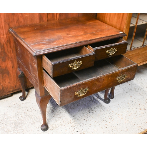 42 - An 18th century walnut three drawer side table, raised on cabriole legs, later brass fittings and a/... 