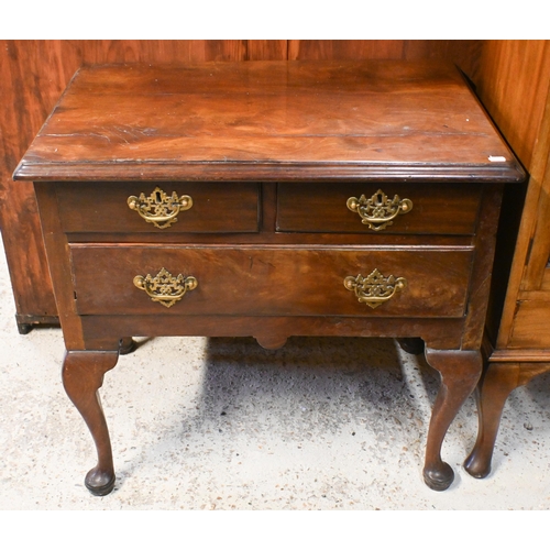 42 - An 18th century walnut three drawer side table, raised on cabriole legs, later brass fittings and a/... 