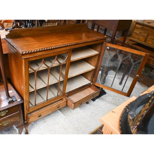 44 - A vintage Gillows style low mahogany two door astragal glazed dwarf bookcase, with two base drawers,... 