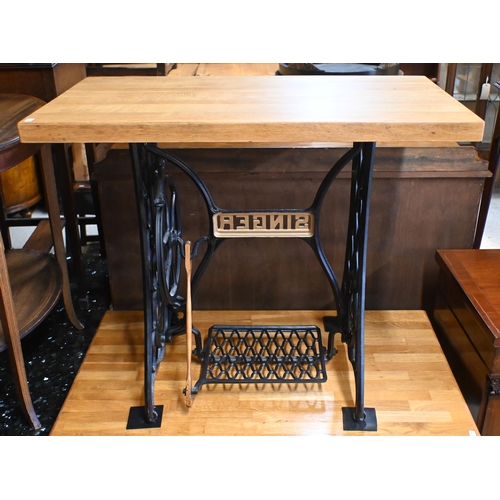 54 - An antique Singer sewing machine cast iron treadle base converted to a solid oak top table 90 cm w x... 