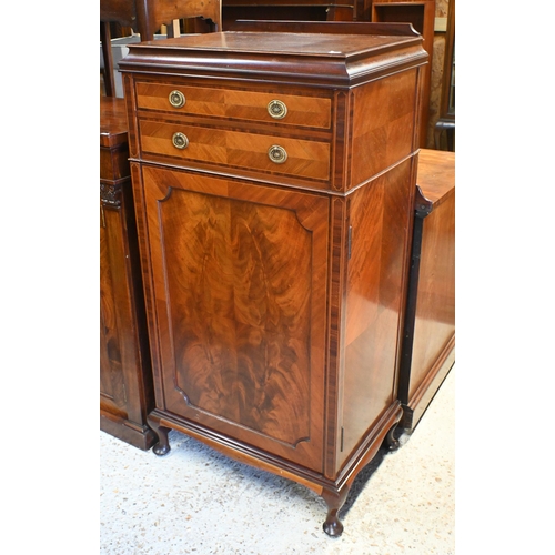 58 - An Edwardian inlaid satinwood music cabinet, with two drawers over a cabinet door enclosing multiple... 