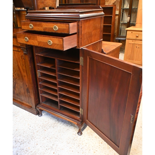 58 - An Edwardian inlaid satinwood music cabinet, with two drawers over a cabinet door enclosing multiple... 